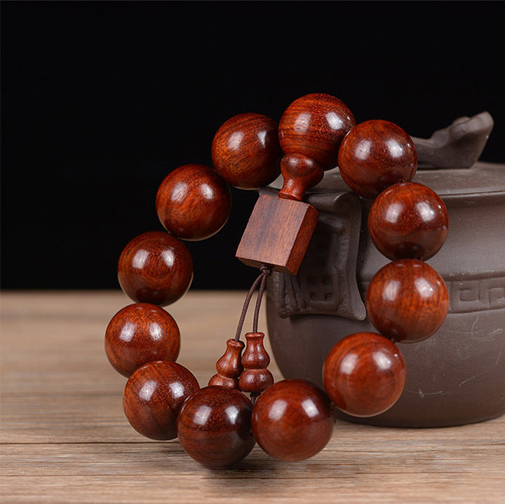 Braccialetto di rilassamento in legno di sandalo rosso con foglie piccole tibetane Buddha Stones