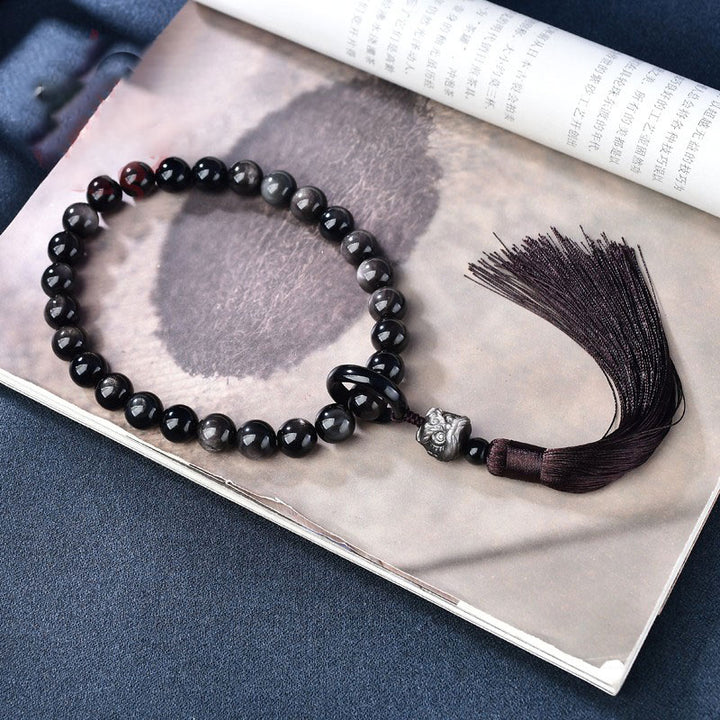 Buddha Stones Argento naturale Ossidiana lucente Leone Mala da polso Protezione Nappe Mala tascabile Decorazione per auto
