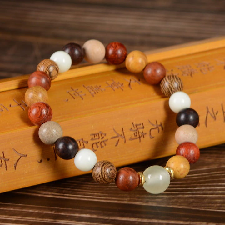 Braccialetto della pace in legno di sandalo rosso e legno di ebano Buddha Stones multicolore