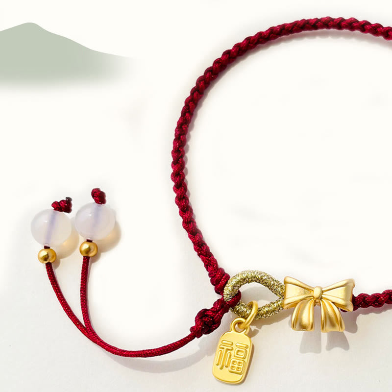 Braccialetto con corda rossa con ciondolo a forma di fiocco con rosetta in fiore di pesco fatto a mano con carattere Fu e nodo Buddha Stones