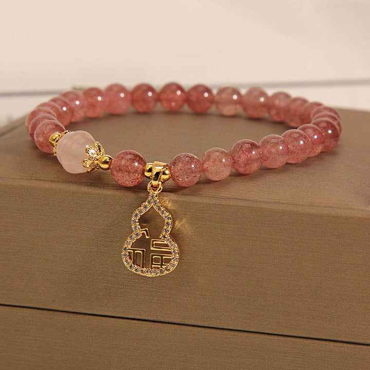 Braccialetto positivo con ciondolo a forma di carattere Fu di zucca e quarzo fragola Buddha Stones