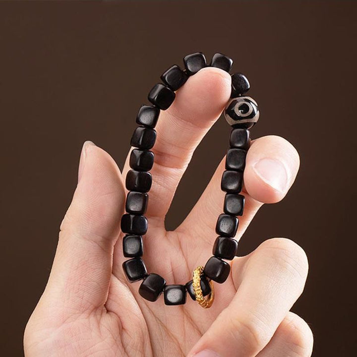 Braccialetto di equilibrio e calma con perline di legno di ebano tibetano Dzi Buddha Stones