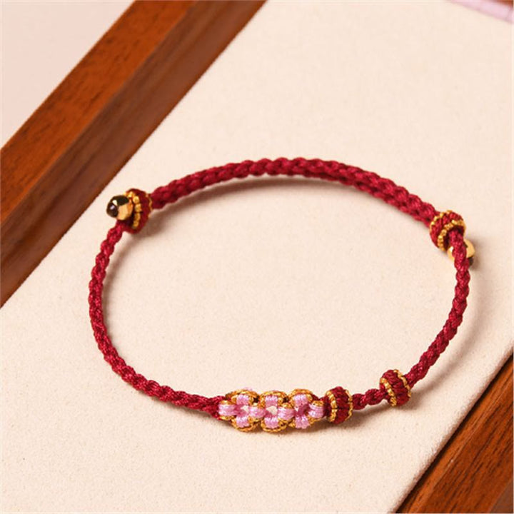 Braccialetto di corda intrecciata con protezione in fiore di pesco fatto a mano Buddha Stones