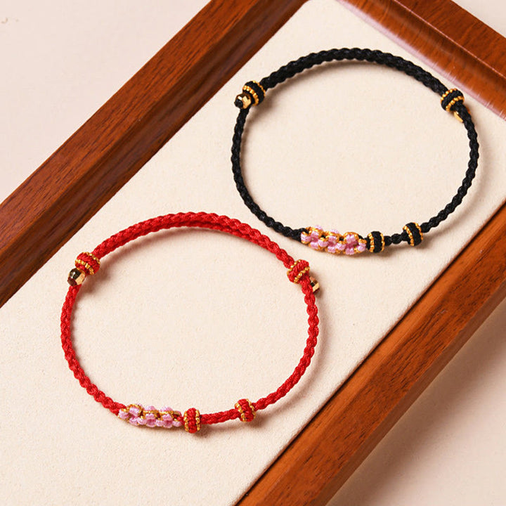 Braccialetto di corda intrecciata con protezione in fiore di pesco fatto a mano Buddha Stones