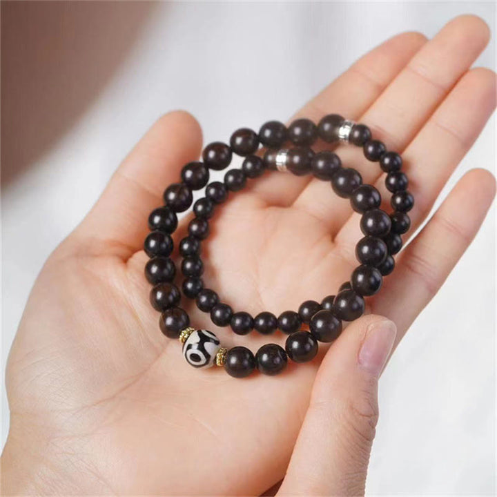 Braccialetto doppio giro in perline di legno di ebano del Tibet Dzi Buddha Stones