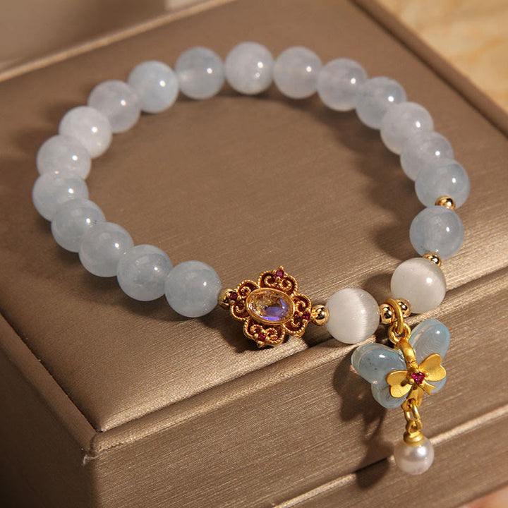 Braccialetto con ciondolo a forma di farfalla e perla con occhio di gatto e pietre Buddha Stones