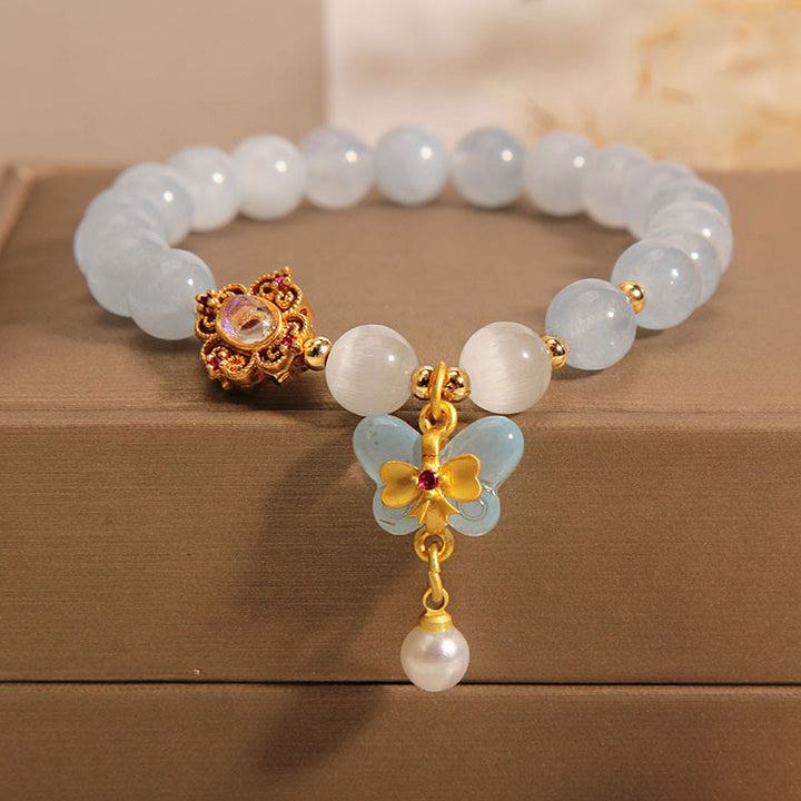 Braccialetto con ciondolo a forma di farfalla e perla con occhio di gatto e pietre Buddha Stones
