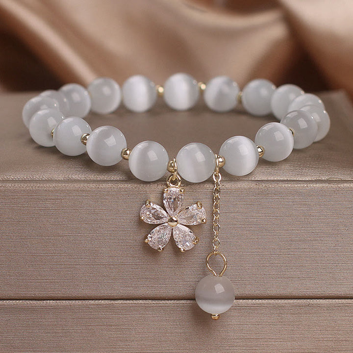 Braccialetto di sostegno alla pace con ciondolo a forma di fiore con occhio di gatto Buddha Stones