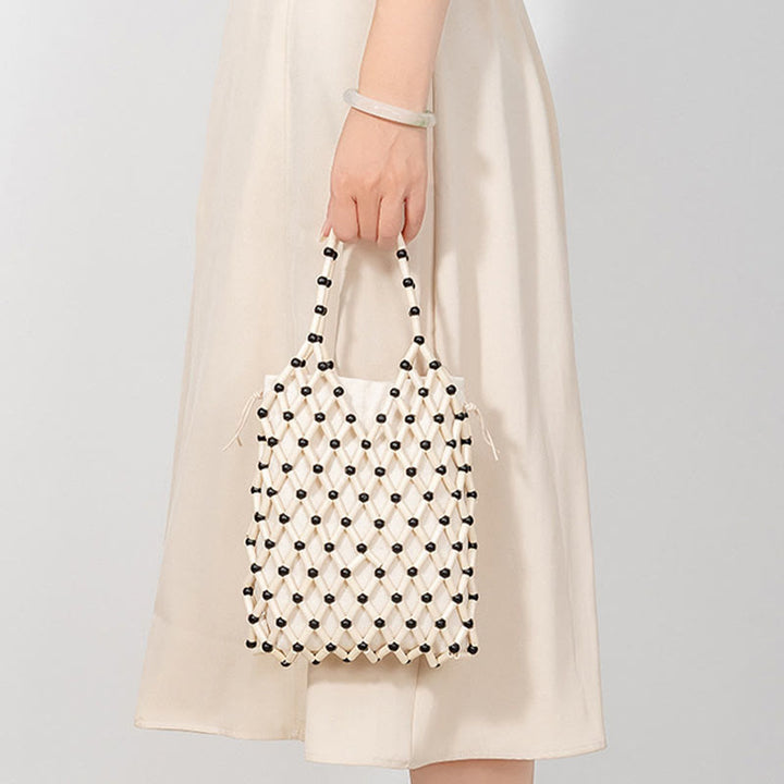 Borsa a mano con perline di legno cave intrecciate a mano in Buddha Stones