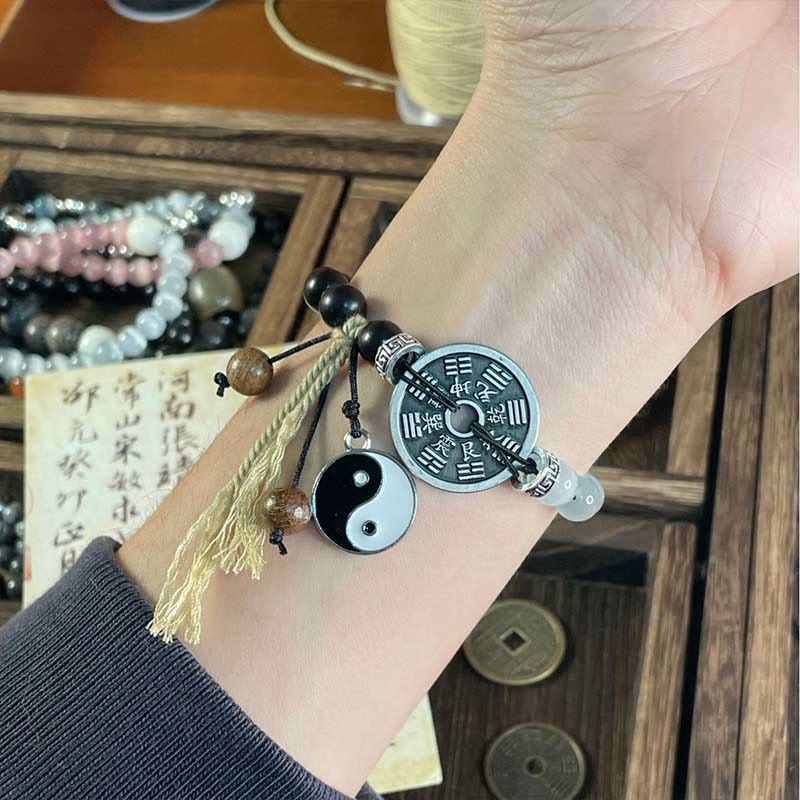 Braccialetto di corda di supporto per monete Bagua in legno di ebano con occhio di gatto Buddha Stones