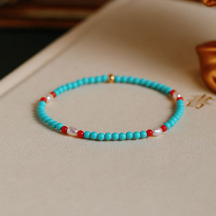 Braccialetto di protezione con piccole perle di agata rossa e turchese Buddha Stones