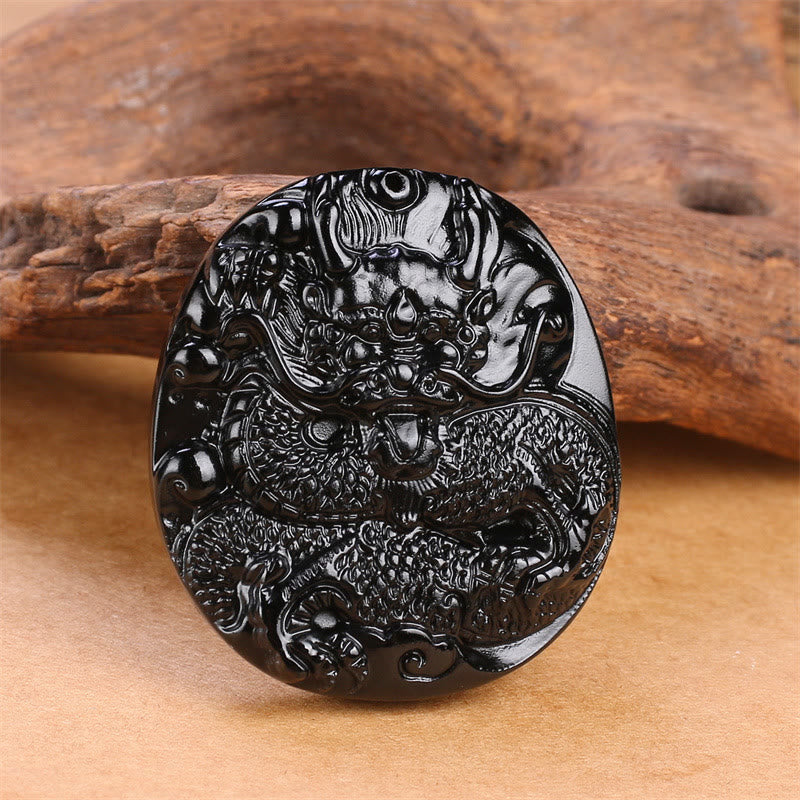Collana con ciondolo di protezione in ossidiana nera naturale con drago intagliato rotondo in Buddha Stones - image 2