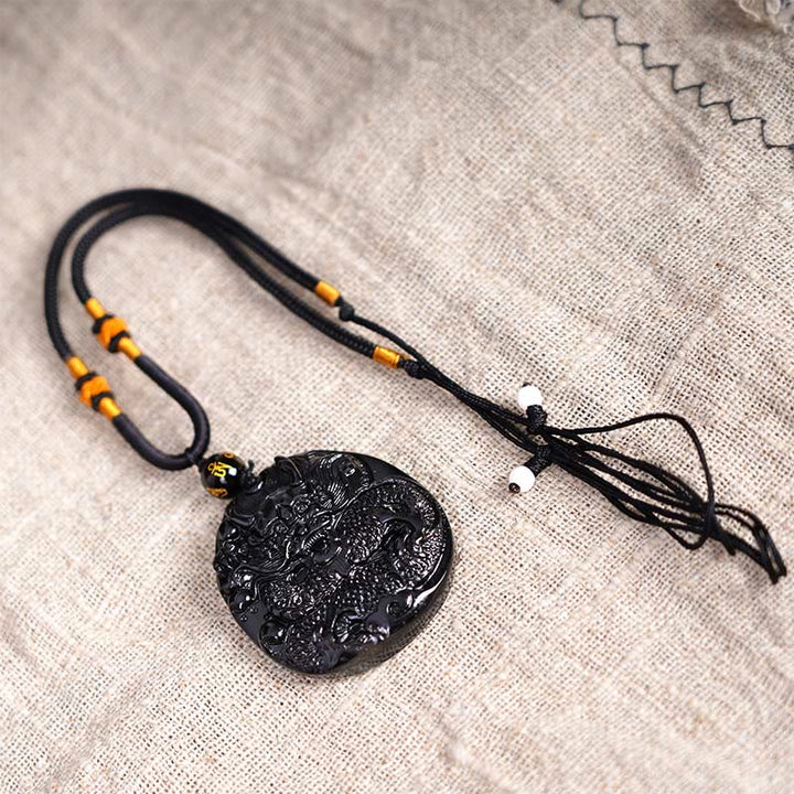Collana con ciondolo di protezione in ossidiana nera naturale con drago intagliato rotondo in Buddha Stones - image 7