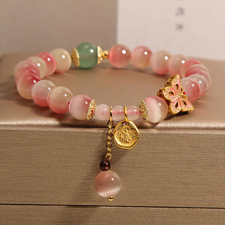 Braccialetto della pace con farfalla occhio di gatto rosa sfumato Buddha Stones