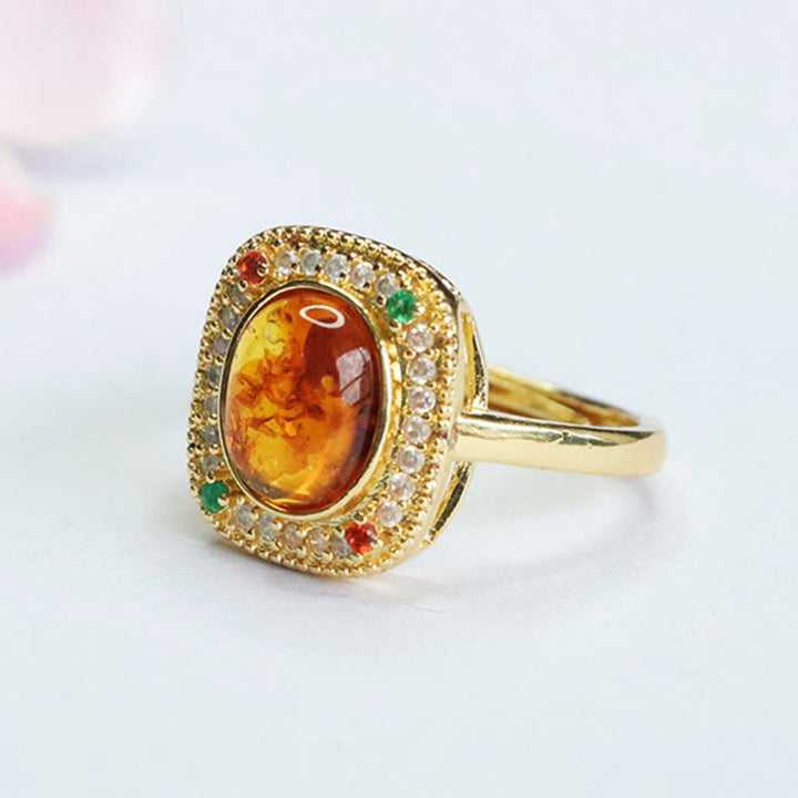 Anello di fiducia con supporto quadrato con fiore di ambra naturale Buddha Stones