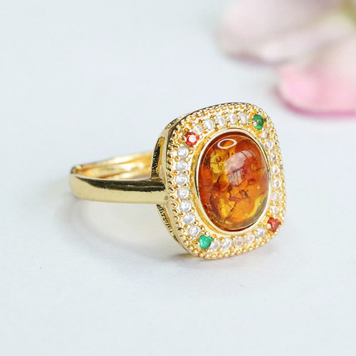 Anello di fiducia con supporto quadrato con fiore di ambra naturale Buddha Stones