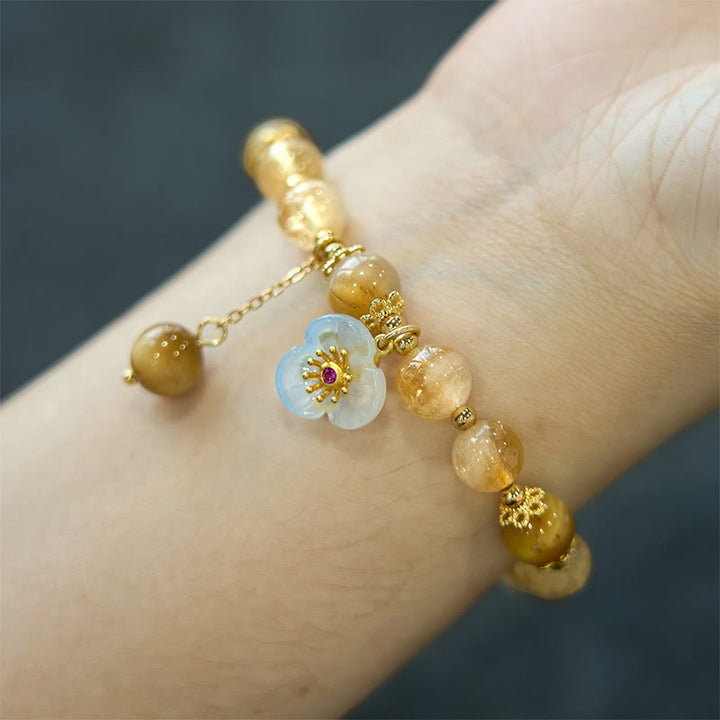 Braccialetto di generosità con ciondolo a forma di fiore con occhio di tigre e citrino Buddha Stones