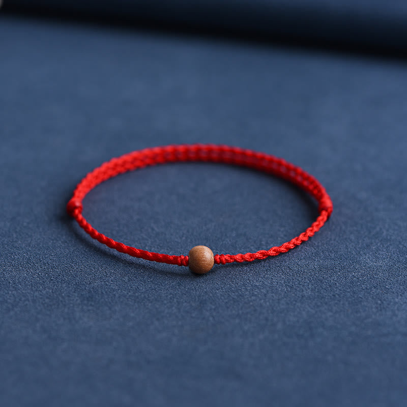 Bracciale intrecciato con perline di legno di pesca naturale Buddha Stones che allontanano gli spiriti maligni
