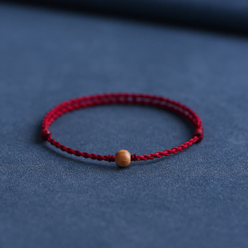 Bracciale intrecciato con perline di legno di pesca naturale Buddha Stones che allontanano gli spiriti maligni