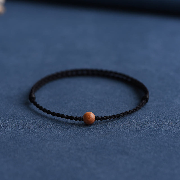 Bracciale intrecciato con perline di legno di pesca naturale Buddha Stones che allontanano gli spiriti maligni