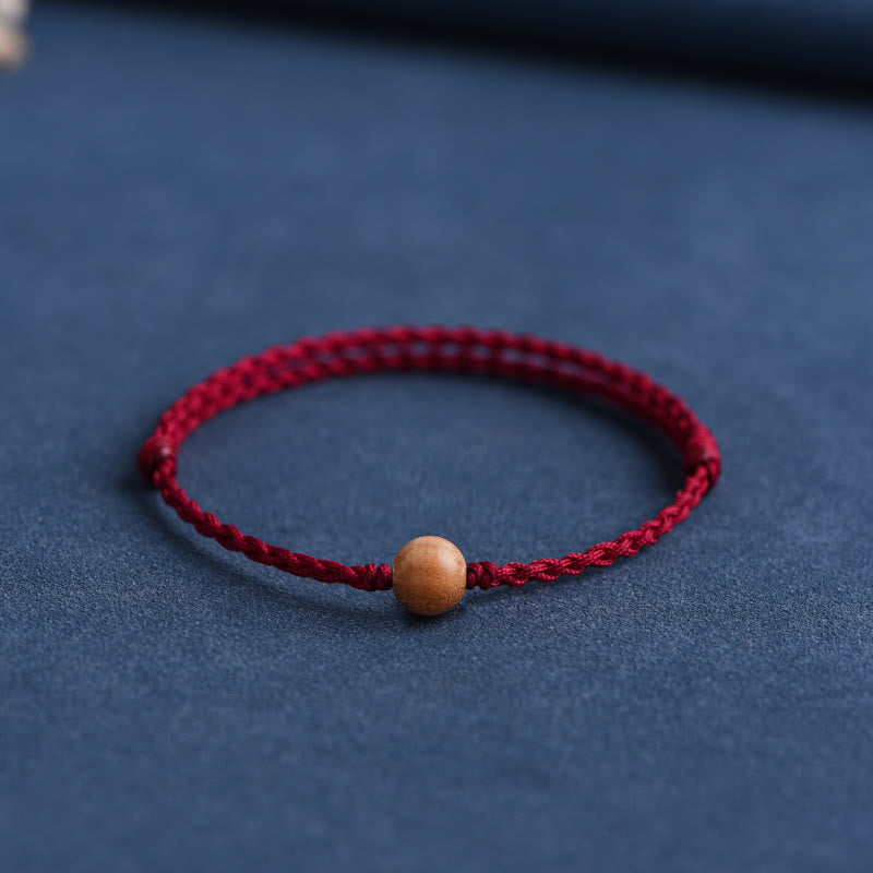 Bracciale intrecciato con perline di legno di pesca naturale Buddha Stones che allontanano gli spiriti maligni