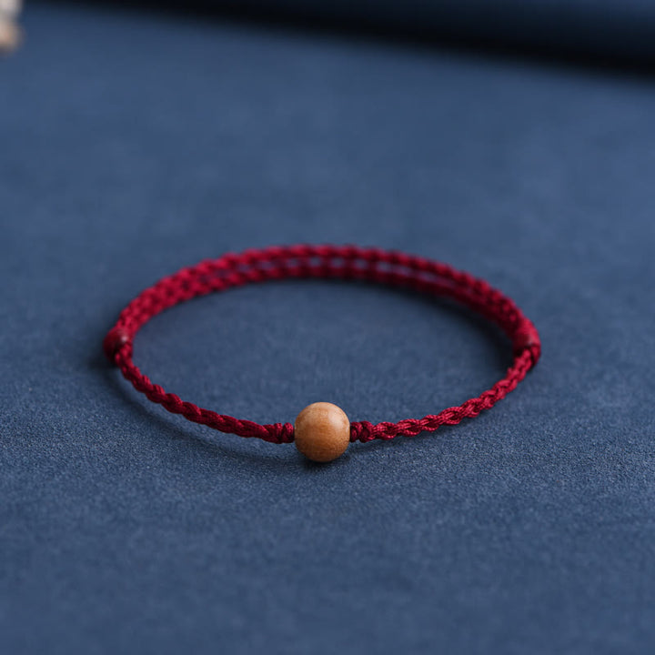 Bracciale intrecciato con perline di legno di pesca naturale Buddha Stones che allontanano gli spiriti maligni