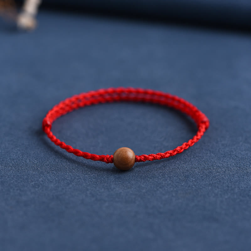 Bracciale intrecciato con perline di legno di pesca naturale Buddha Stones che allontanano gli spiriti maligni