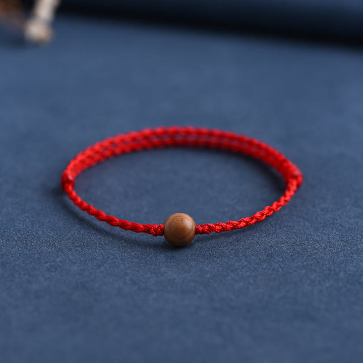 Bracciale intrecciato con perline di legno di pesca naturale Buddha Stones che allontanano gli spiriti maligni