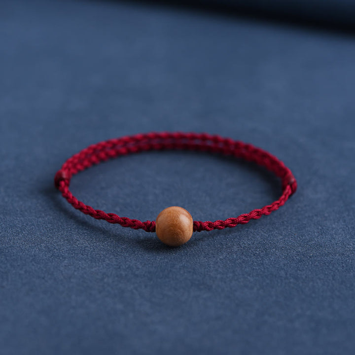 Bracciale intrecciato con perline di legno di pesca naturale Buddha Stones che allontanano gli spiriti maligni
