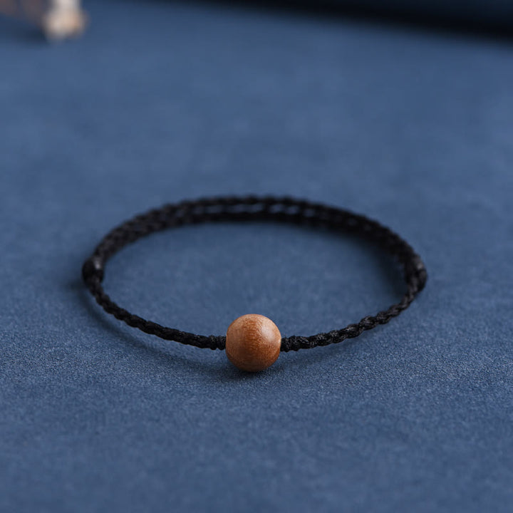 Bracciale intrecciato con perline di legno di pesca naturale Buddha Stones che allontanano gli spiriti maligni