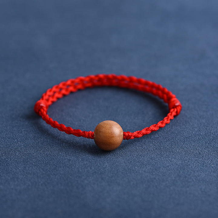 Bracciale intrecciato con perline di legno di pesca naturale Buddha Stones che allontanano gli spiriti maligni