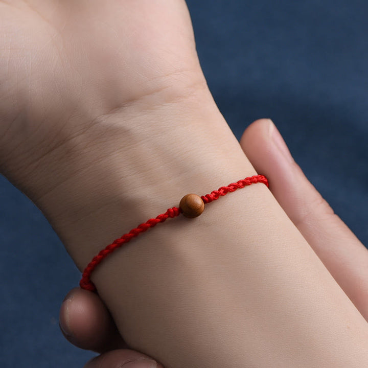 Bracciale intrecciato con perline di legno di pesca naturale Buddha Stones che allontanano gli spiriti maligni