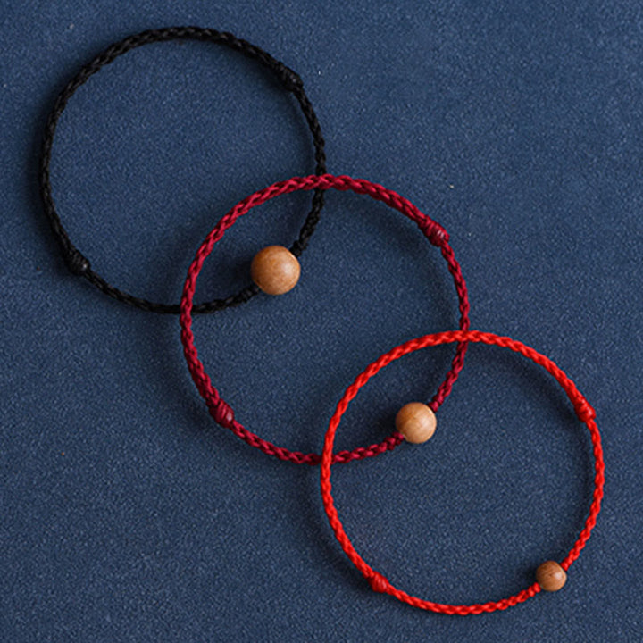 Bracciale intrecciato con perline di legno di pesca naturale Buddha Stones che allontanano gli spiriti maligni