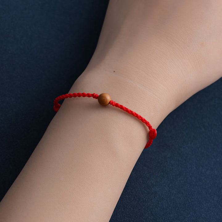 Bracciale intrecciato con perline di legno di pesca naturale Buddha Stones che allontanano gli spiriti maligni