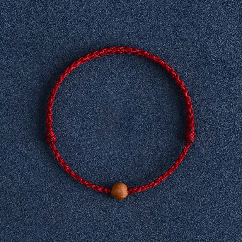 Bracciale intrecciato con perline di legno di pesca naturale Buddha Stones che allontanano gli spiriti maligni