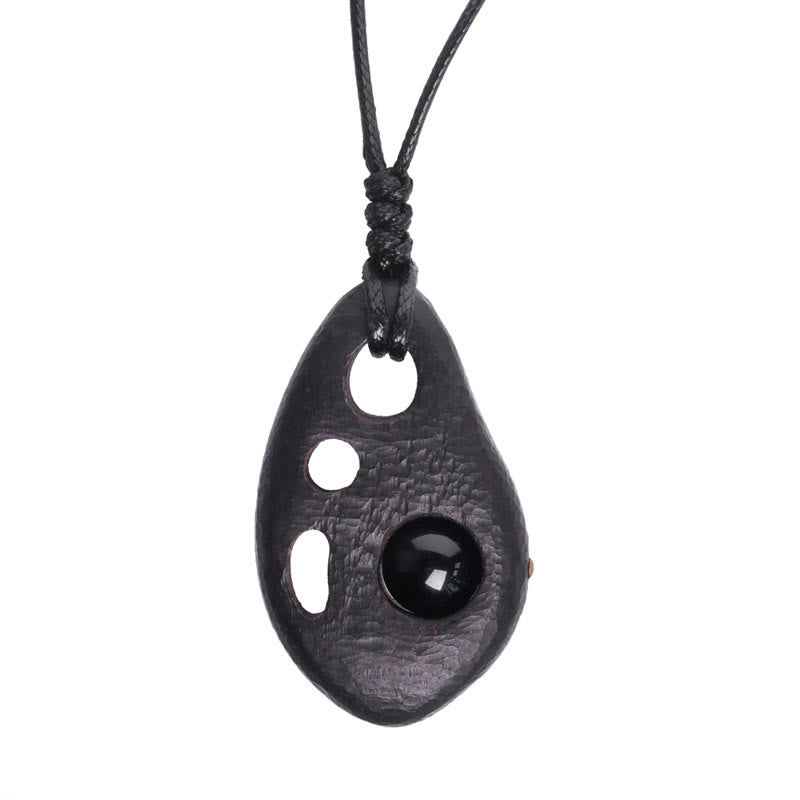 Collana con ciondolo in ossidiana intarsiata cava in legno di ebano Buddha Stones, pace e calma