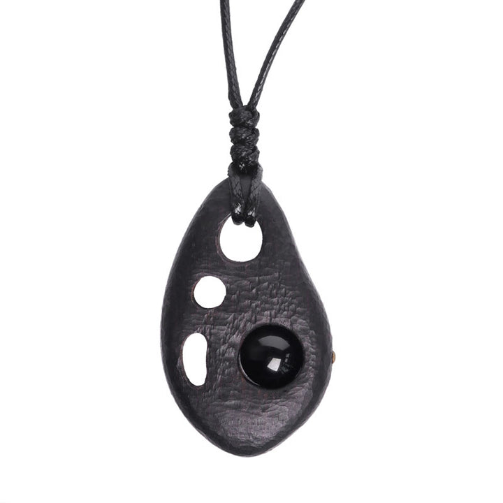 Collana con ciondolo in ossidiana intarsiata cava in legno di ebano Buddha Stones, pace e calma
