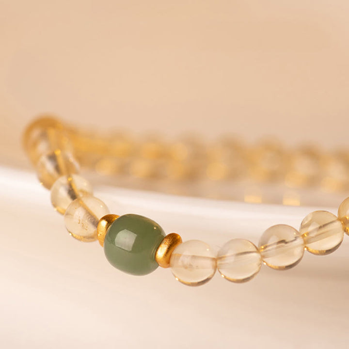 Braccialetto della prosperità con piccole perle di giada citrina e Buddha Stones