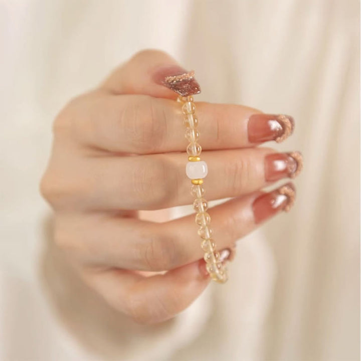 Braccialetto della prosperità con piccole perle di giada citrina e Buddha Stones
