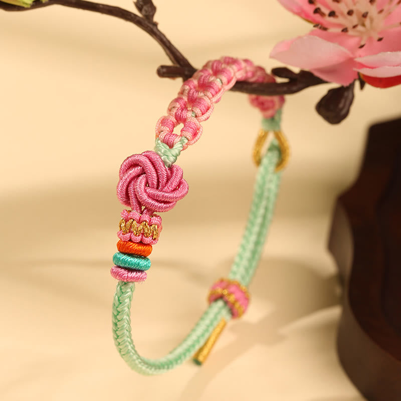 Bracciale intrecciato con nodo in fiore di pesco rosa e verde fatto a mano Buddha Stones