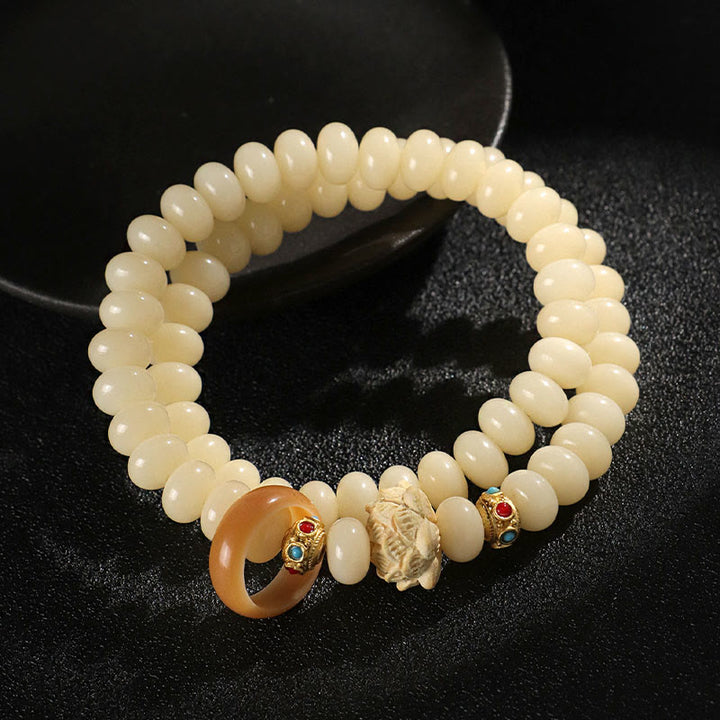 Braccialetto doppio giro Buddha Stones Bodhi Seed Peach Wood Lotus Wealth