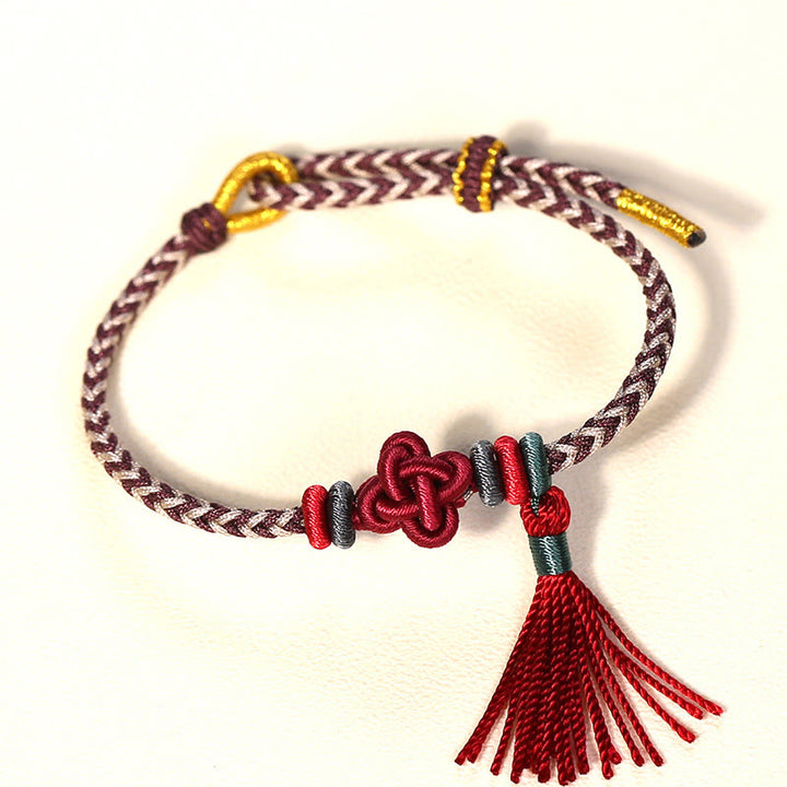 Braccialetto di protezione con nappe con nodo in fiore di pesco e Buddha Stones colorate