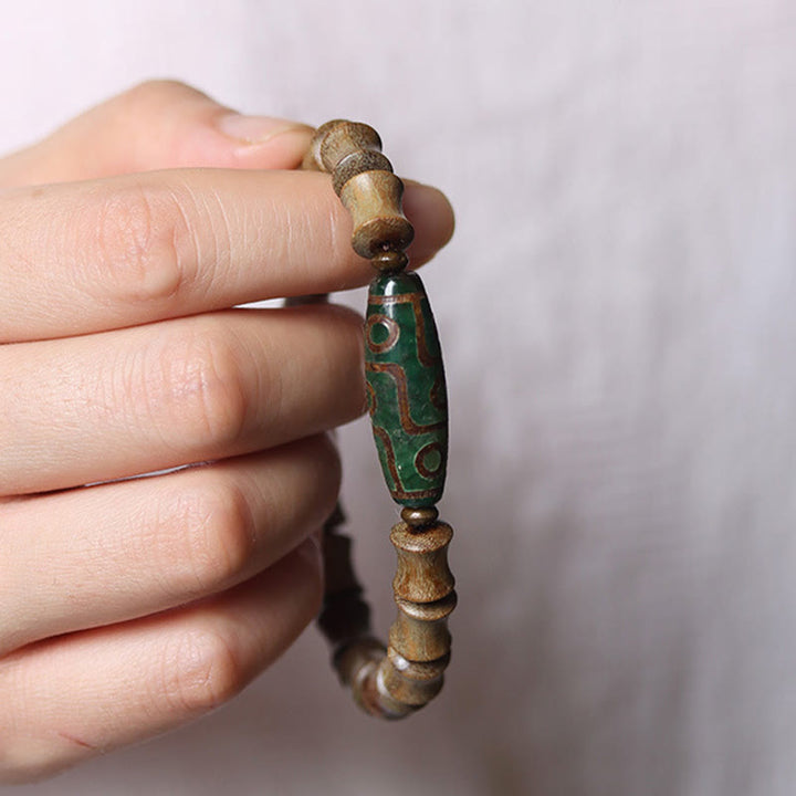 Braccialetto della pace in legno di sandalo verde con perline Dzi tibetane a nove occhi Buddha Stones