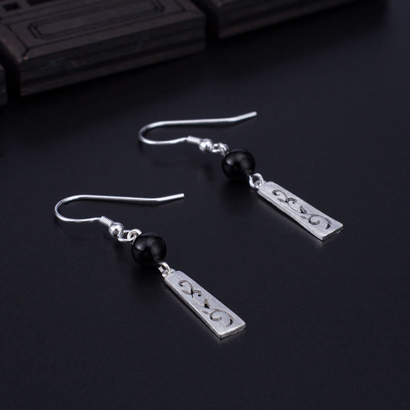 Orecchini pendenti con protezione a forma di vite cava in onice nero in argento sterling 925 Buddha Stones - image 1