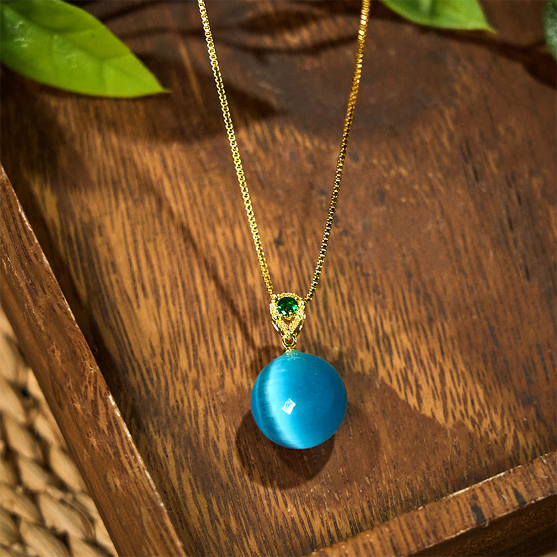 Buddha Stones Collana con ciondolo a forma di palla rotonda con occhio di gatto e simbolo di fiducia - image 1