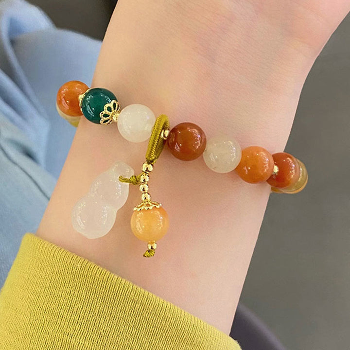 Braccialetto di fortuna e ricchezza di zucca con perle di giada di seta dorata e Buddha Stones