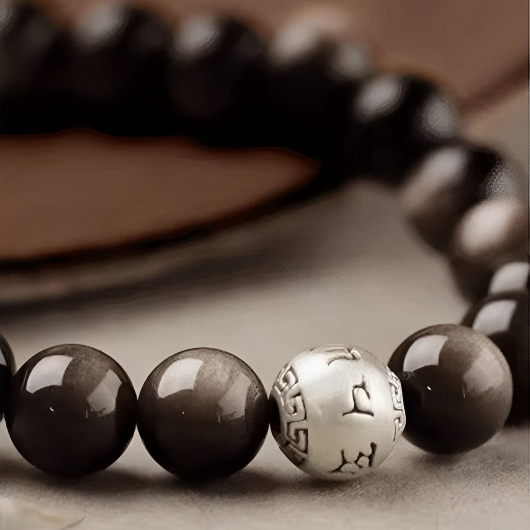 Bracciale di protezione Om Mani Padme Hum in ossidiana naturale lucida e argento Buddha Stones