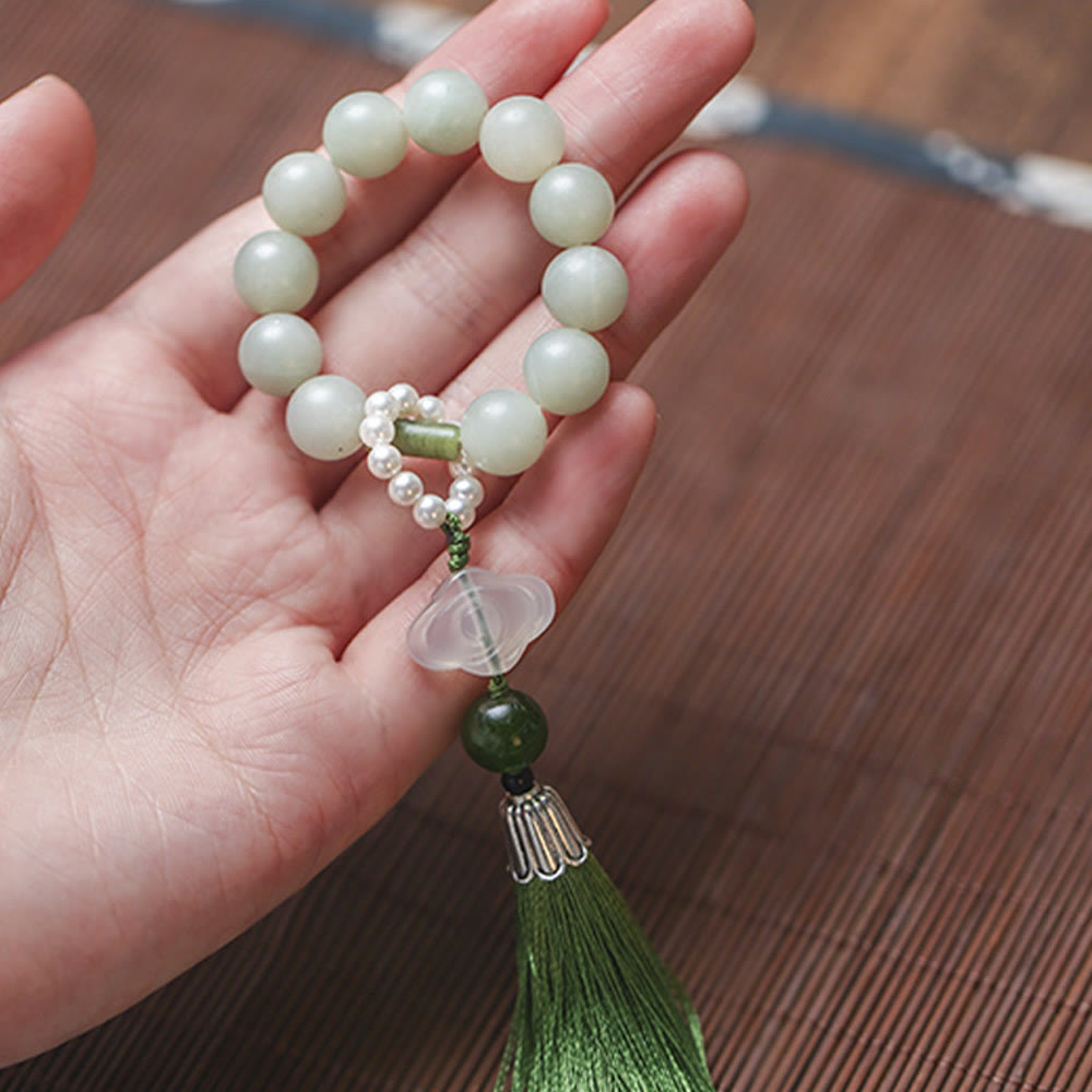 Mala da polso Buddha Stones, perle di giada verde e nappe di prosperità.