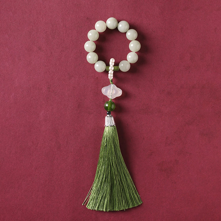 Mala da polso Buddha Stones, perle di giada verde e nappe di prosperità.