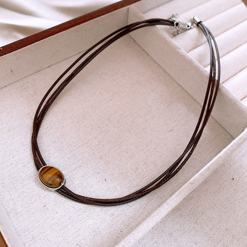 Collana con ciondolo in corda di cera con protezione ellittica in occhio di tigre naturale Buddha Stones